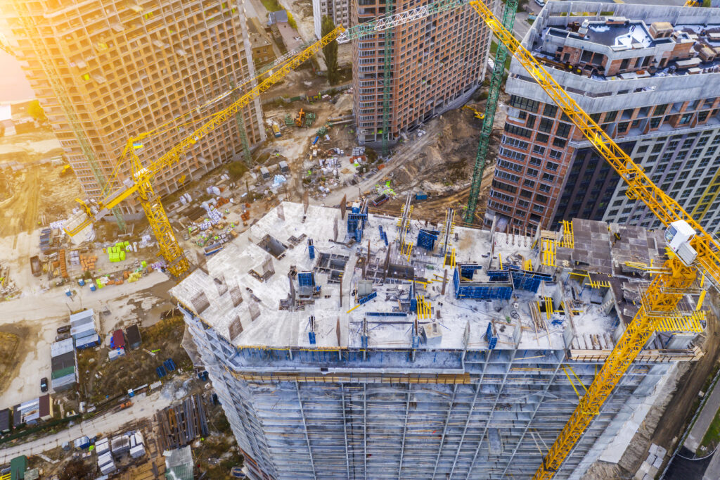 Construction site with cranes at sunset. Construction of an apartment building.